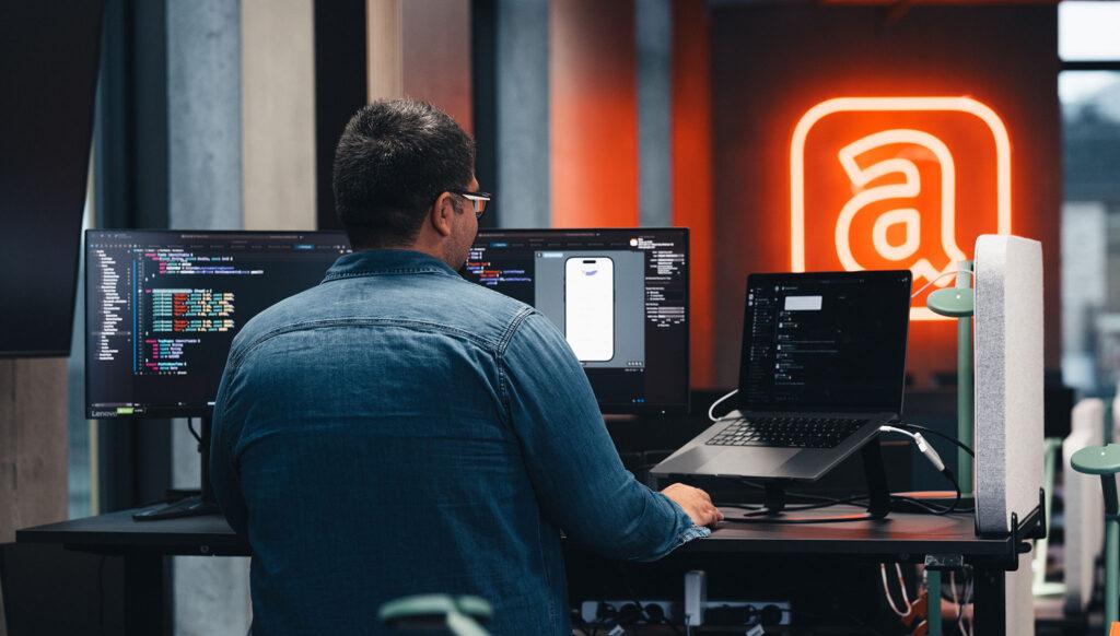 Man working in Acubiz with 2 screens