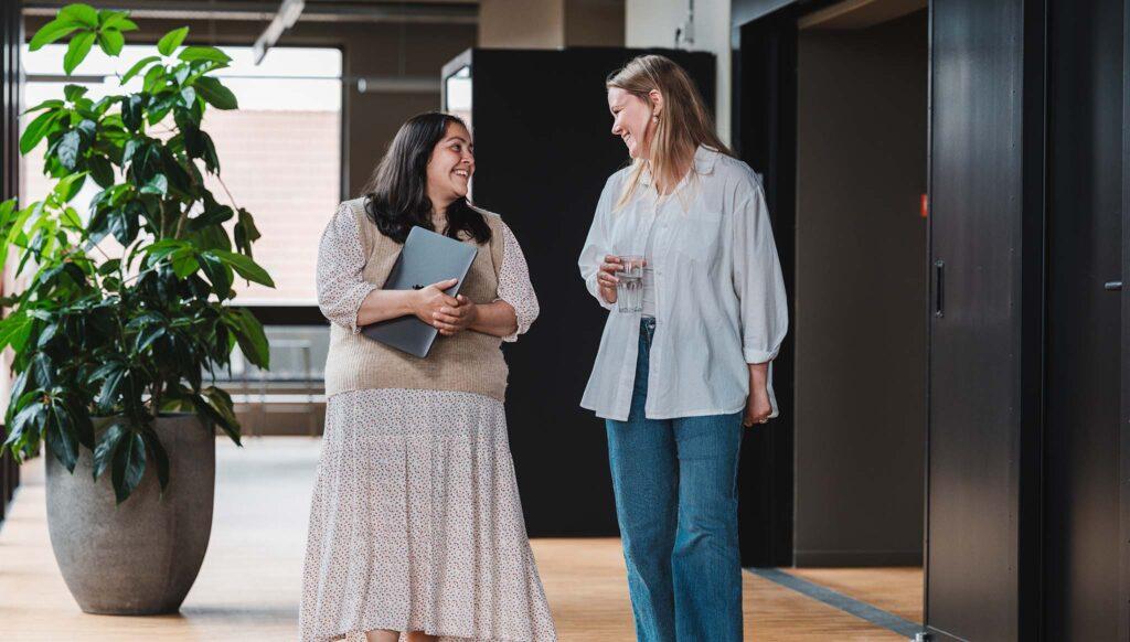 Coworkers walking and smiling