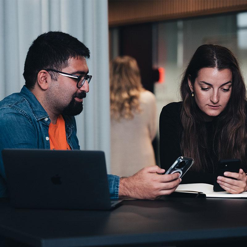 coworkers talking with phone