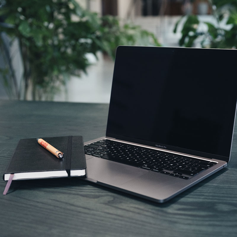 Macbook and notebook on the table