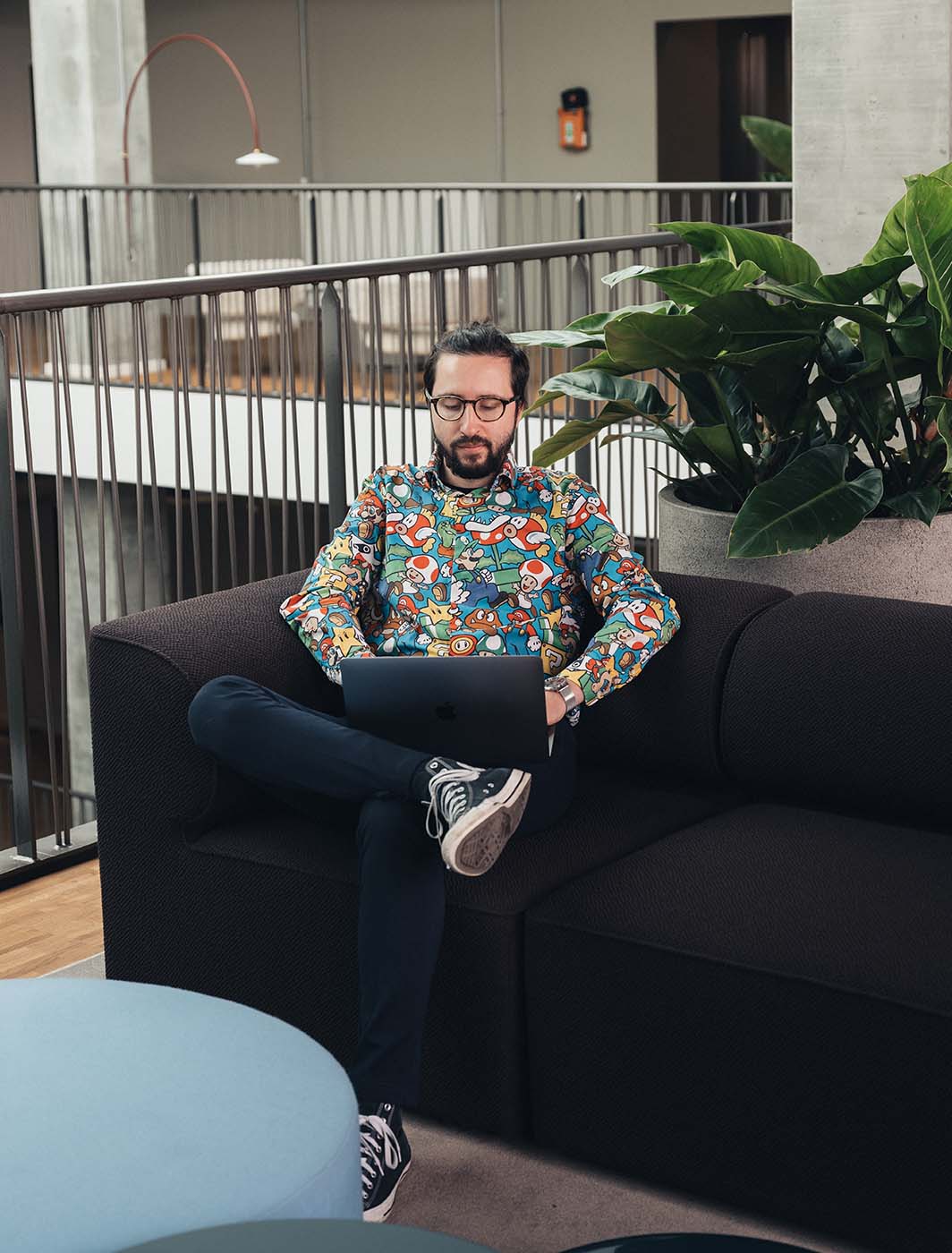 man sitting on couch with computer
