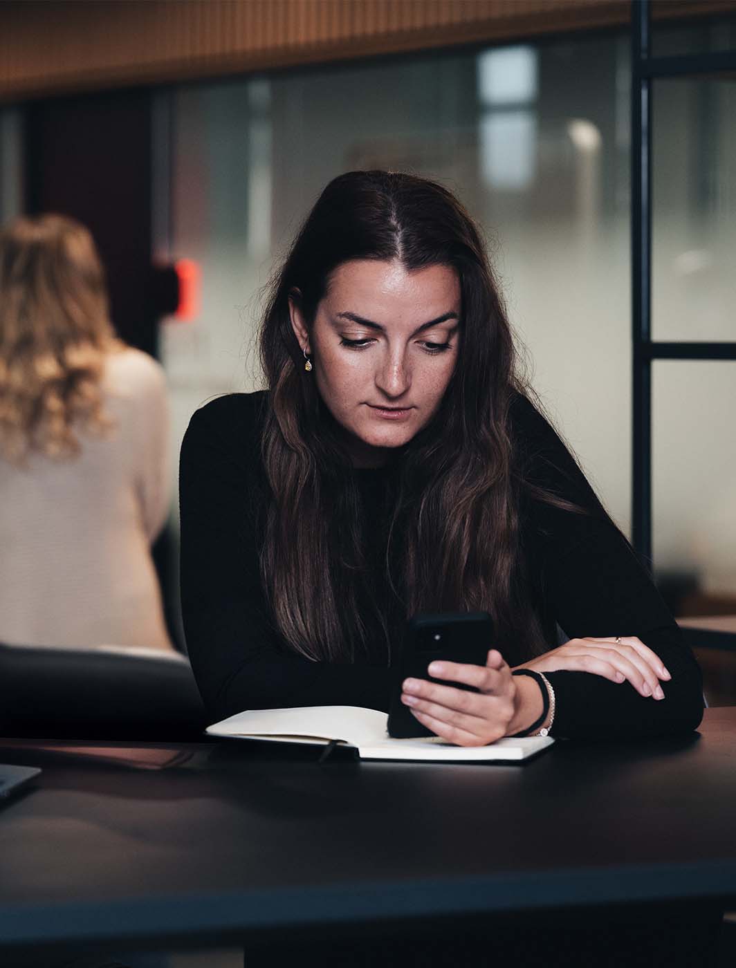 woman sitting with phone