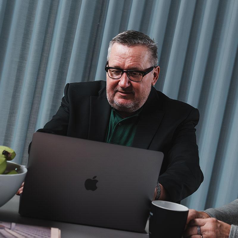 Management sitting with a computer